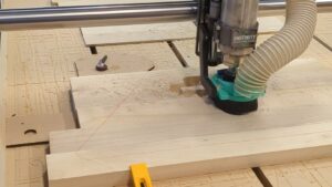 Onefinity Foreman Elite CNC at Maker Cube cutting a hardwood workpiece with a VFD spindle and custom 3D-printed dust shoe (Langley, BC)