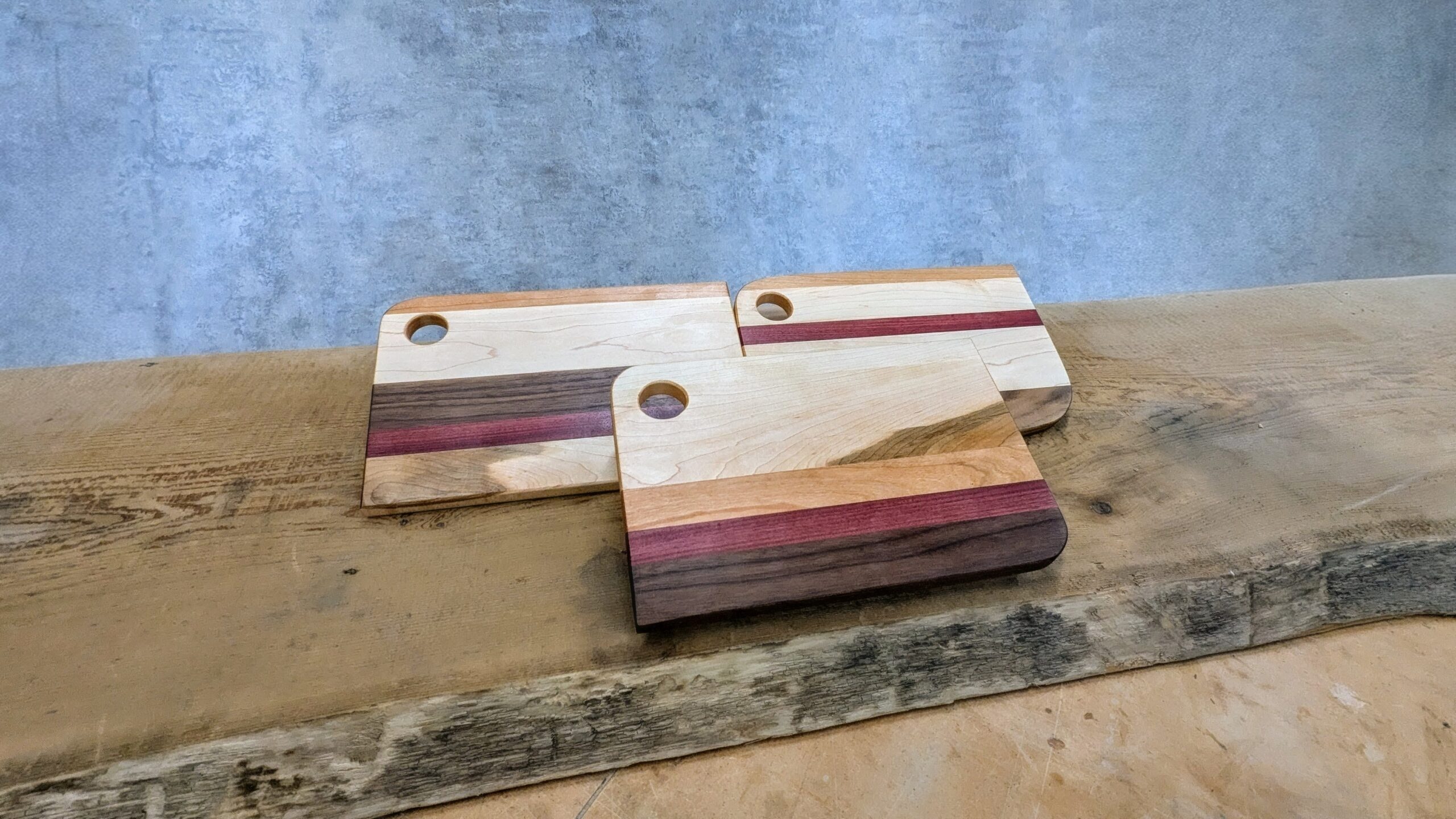 Finished maple, walnut, and cherry charcuterie boards from our beginner woodworking class in Langley, BC.