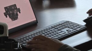 Over the shoulder photo of a participant using Fusion 360 during class at Maker Cube in Langley, BC, with the model and timeline visible on screen
