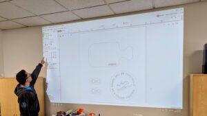 Instructor Doug Chan teaching VCarve Pro at Maker Cube’s computer lab in Langley, BC, looking up at a projected screen of the software