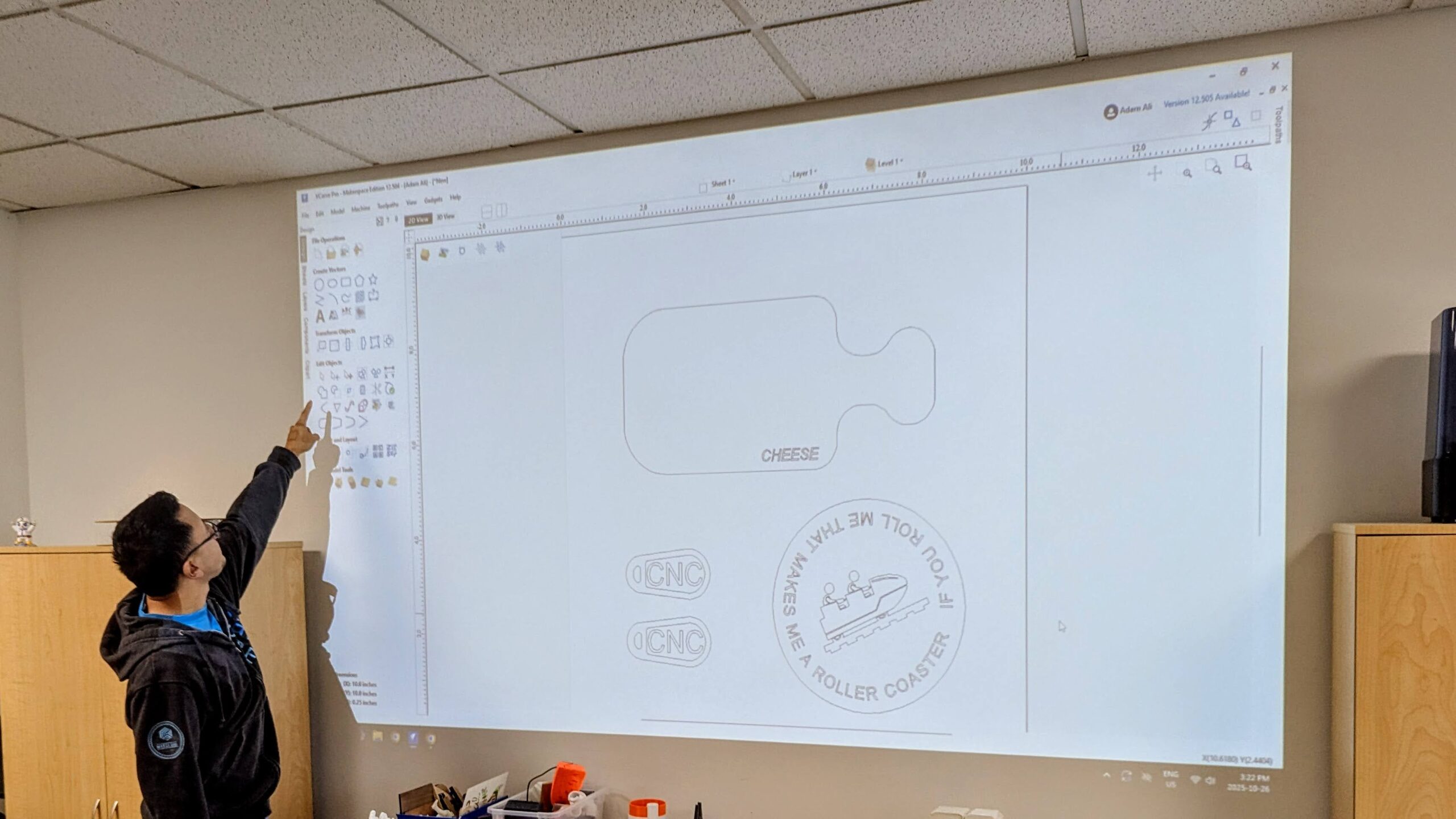 Instructor Doug Chan teaching VCarve Pro at Maker Cube’s computer lab in Langley, BC, looking up at a projected screen of the software